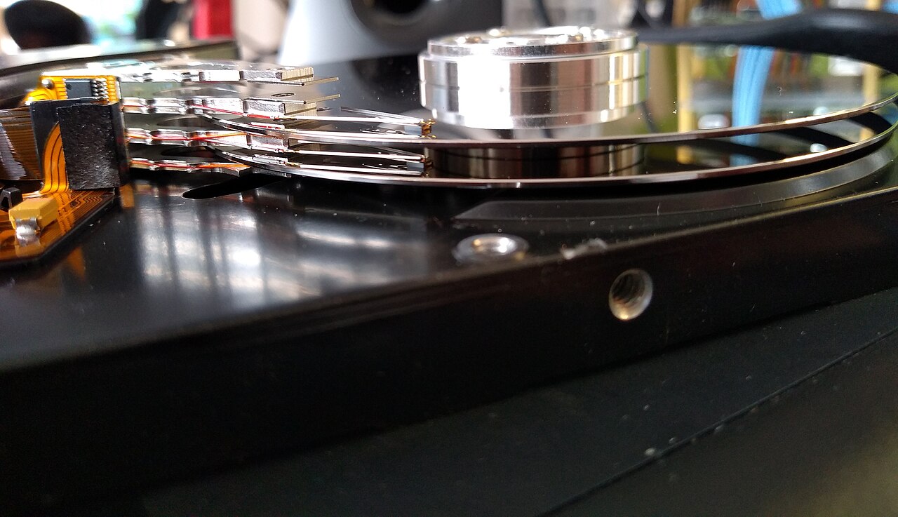 A hard disk drive opened to show its internal platters and actuator arm